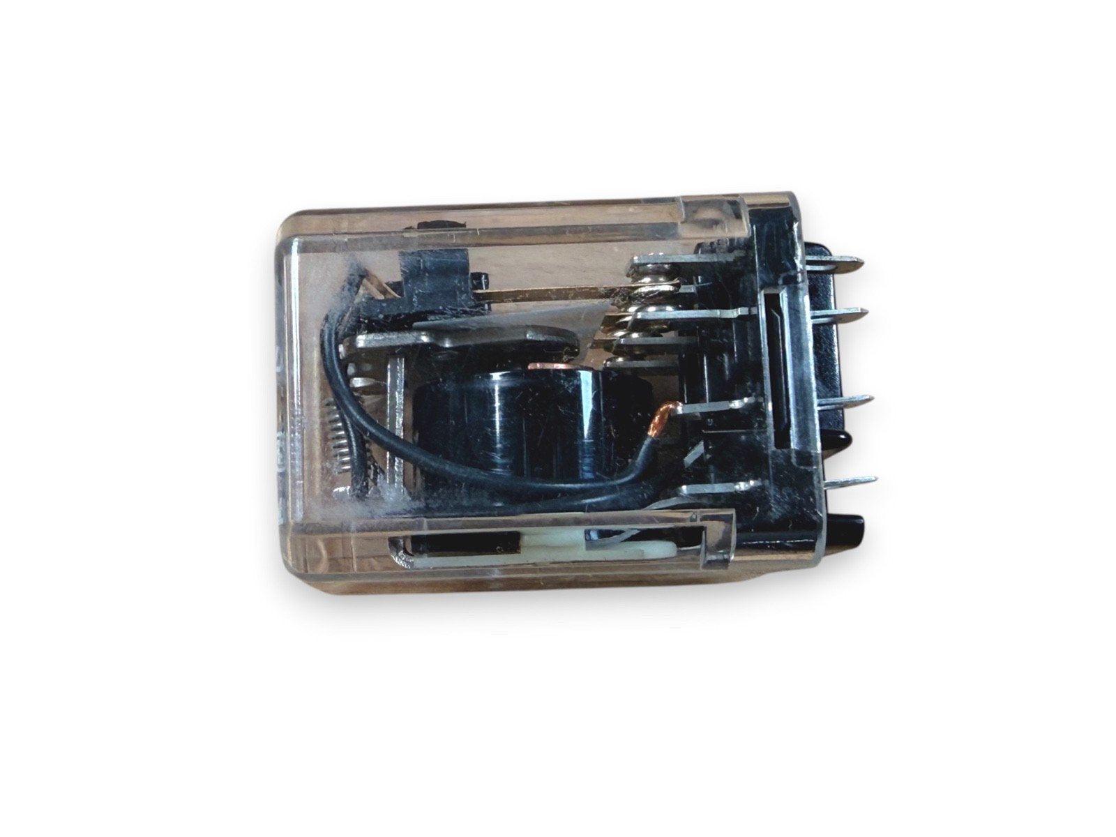 Fire alarm relay component with transparent housing and metal contacts for electrical systems
