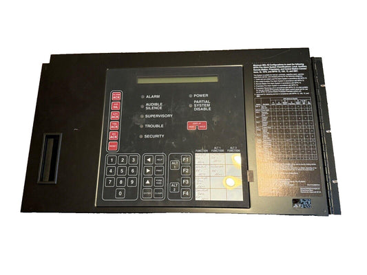 Fire alarm control panel with keypad, status lights, and NFPA compliance chart for commercial safety systems