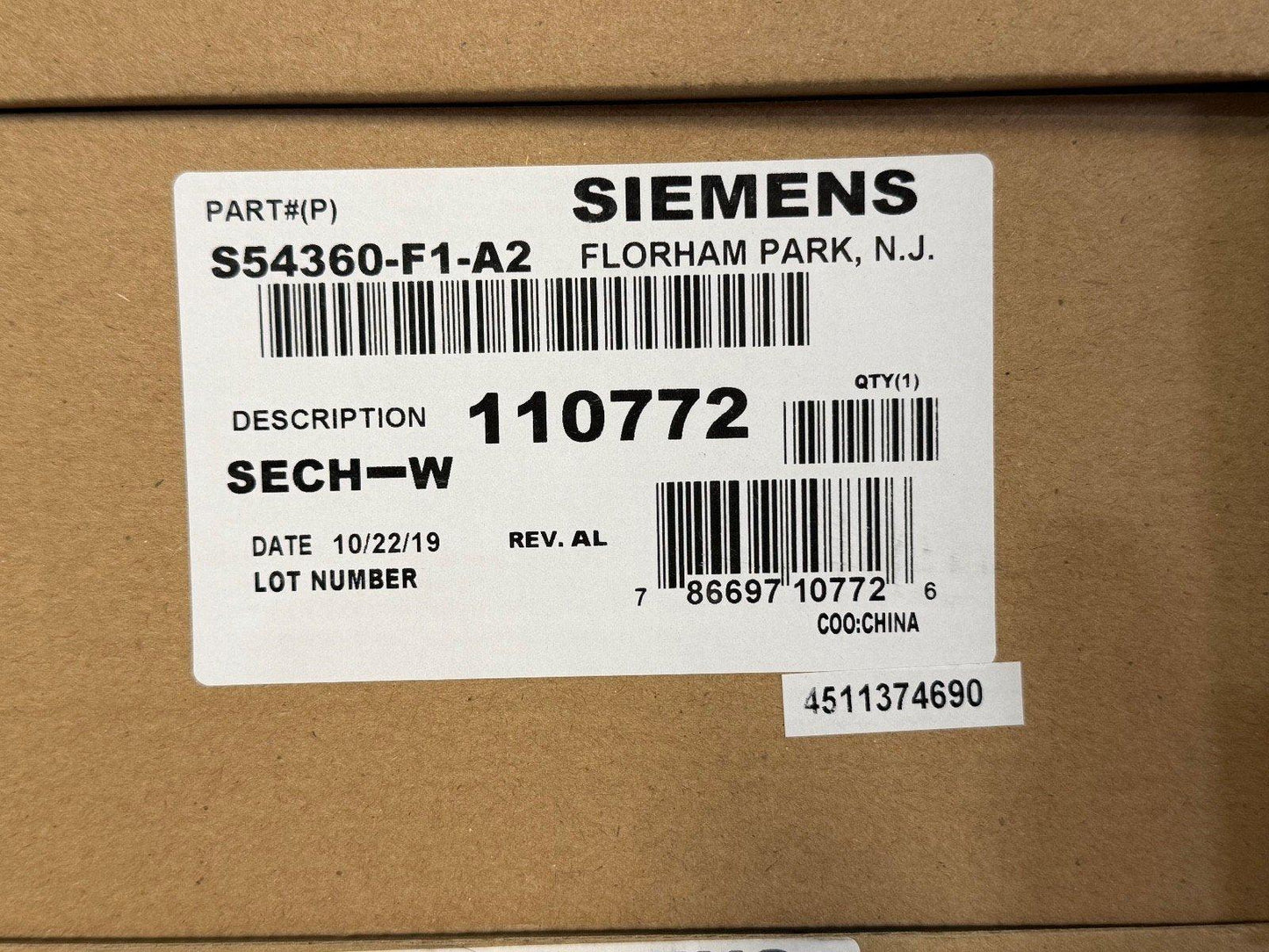 Siemens fire alarm part S54360-F1-A2 SECH-W in original packaging, labeled with barcode and lot details