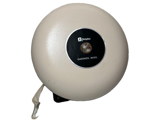 Simplex fire alarm bell with Gardner, Mass. label, beige round housing for fire safety systems
