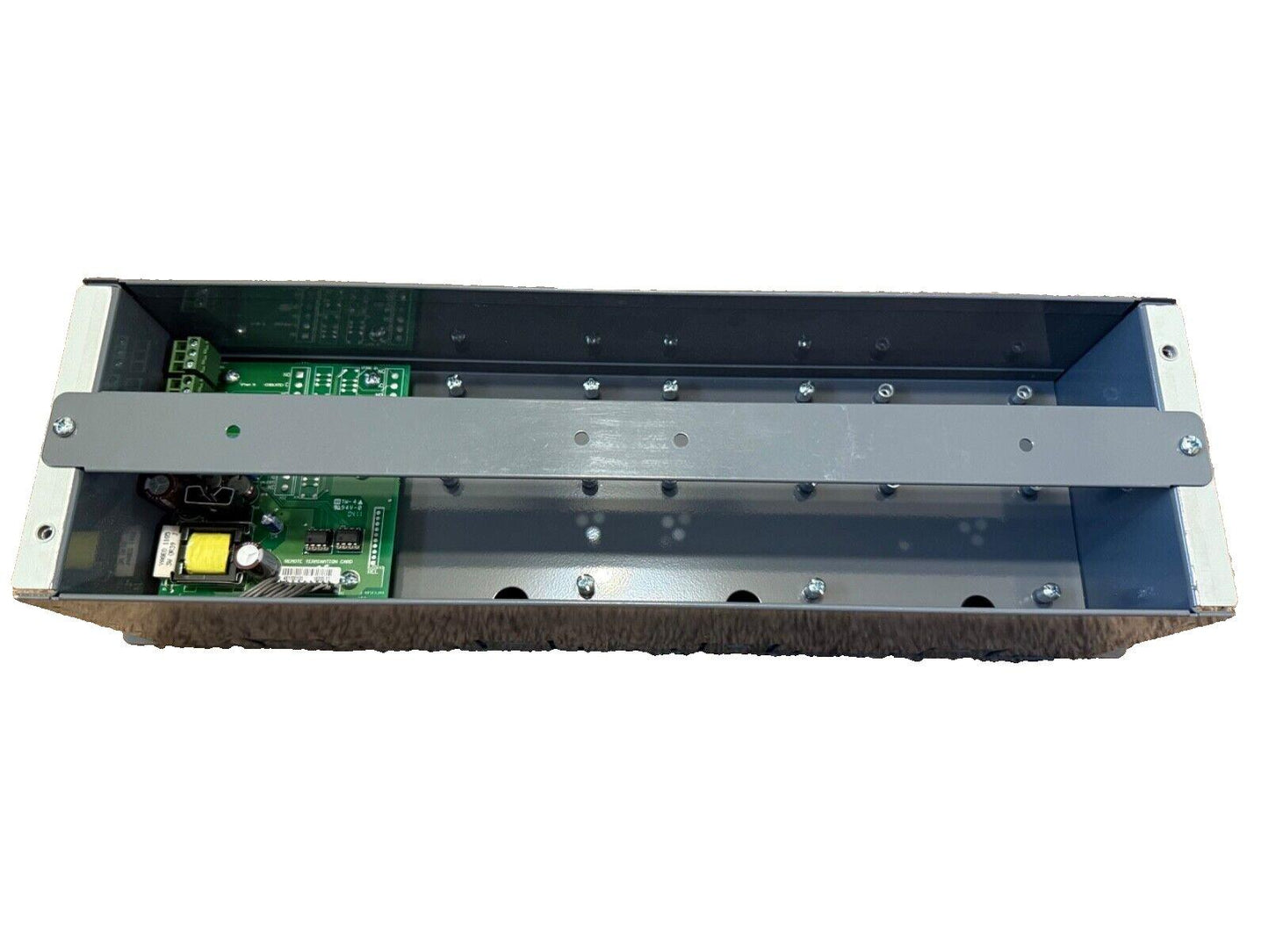 Open fire alarm control panel with internal circuit boards and metal housing