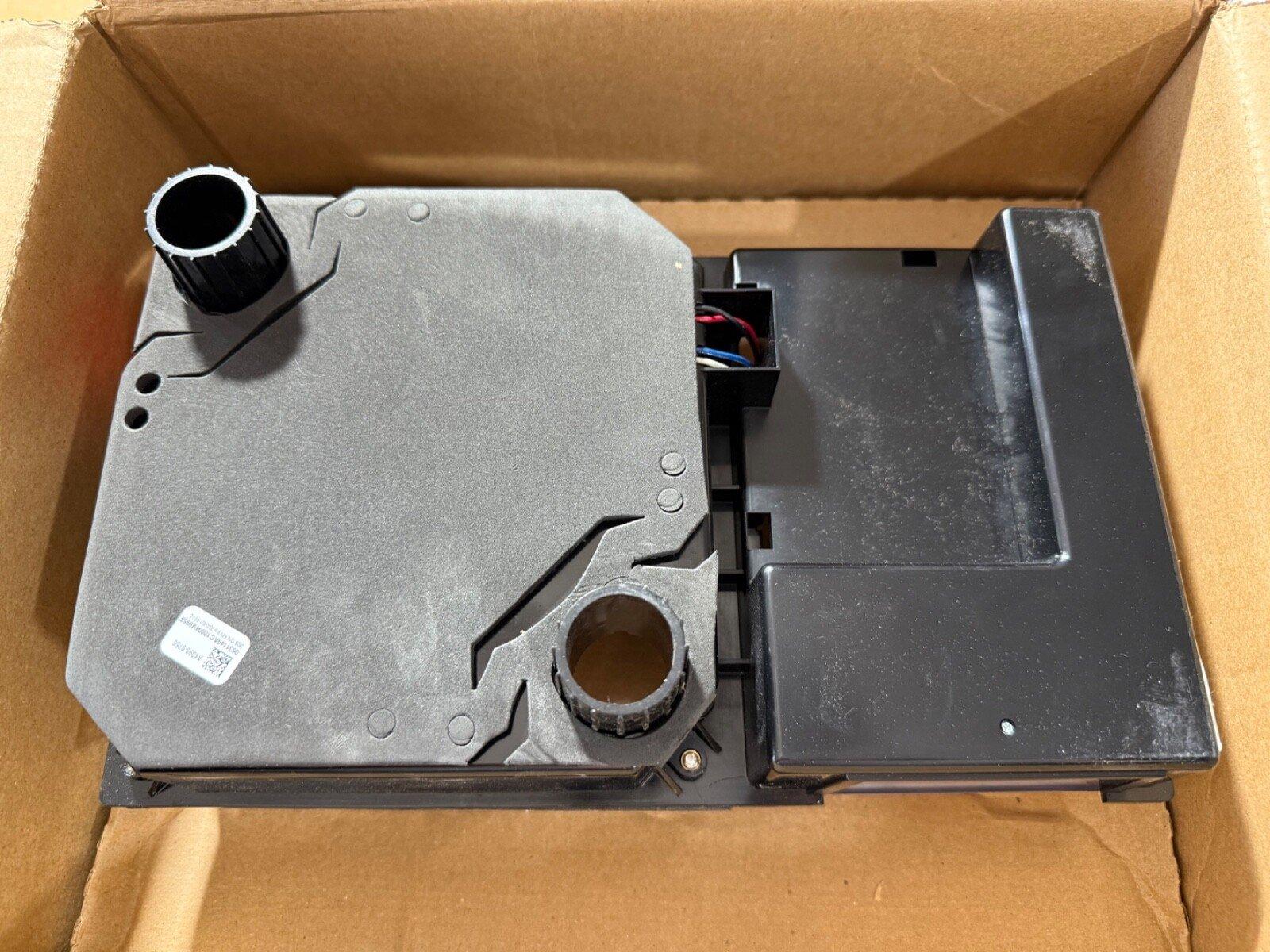 Fire alarm control panel component with wiring, housed in cardboard box for shipping or storage.
