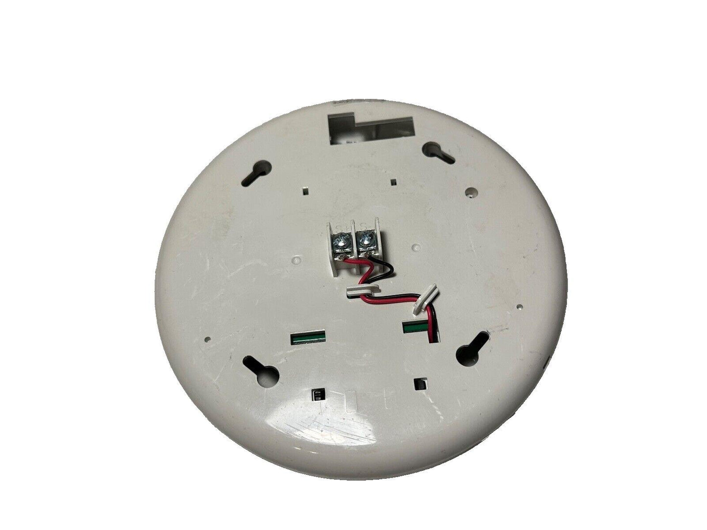 White fire alarm detector back with wiring terminals and mounting slots