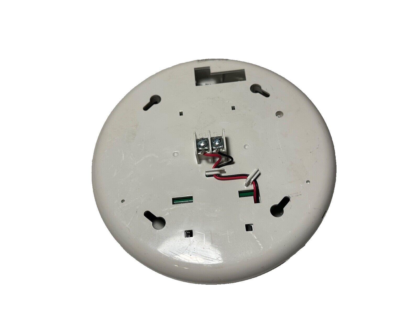 White fire alarm detector back with wiring terminals and mounting slots