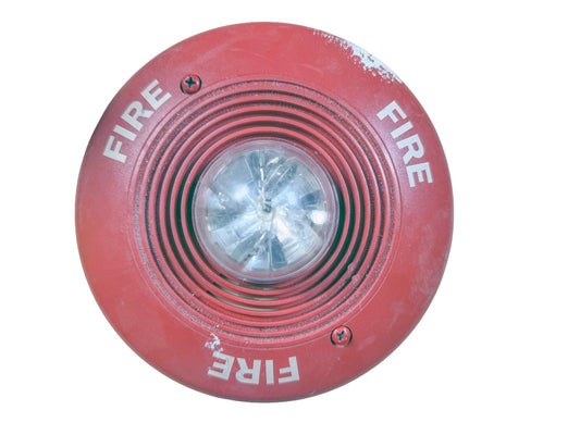 Red fire alarm strobe light with 'FIRE' text, used fire safety equipment
