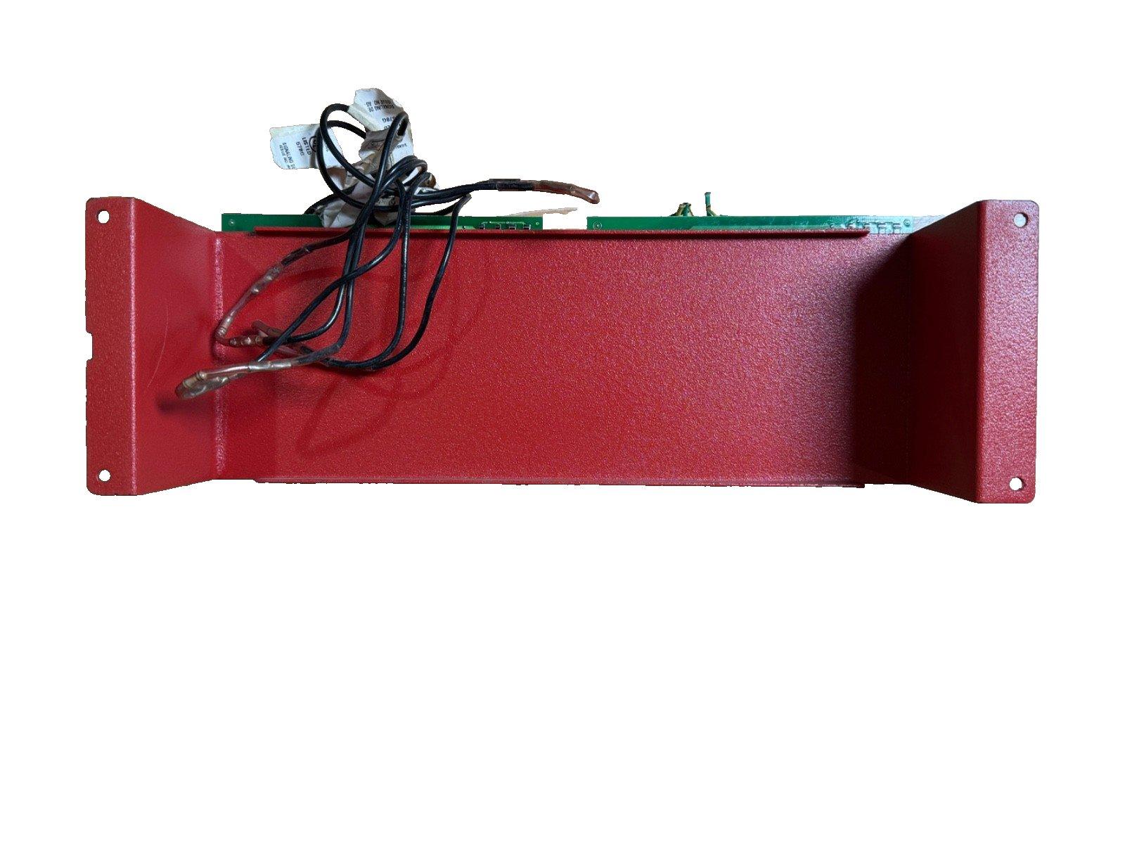 Red fire alarm control panel with wiring and circuit board, used fire safety equipment