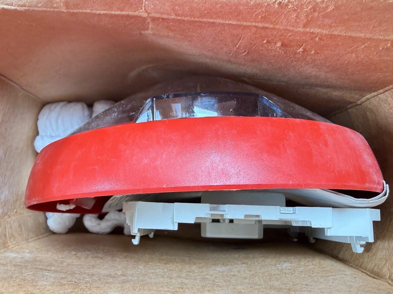Red fire alarm strobe light in cardboard box, new surplus equipment