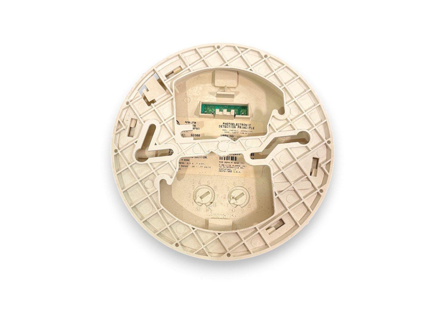 Used photoelectric smoke detector with exposed circuit board and mounting base, model SD380