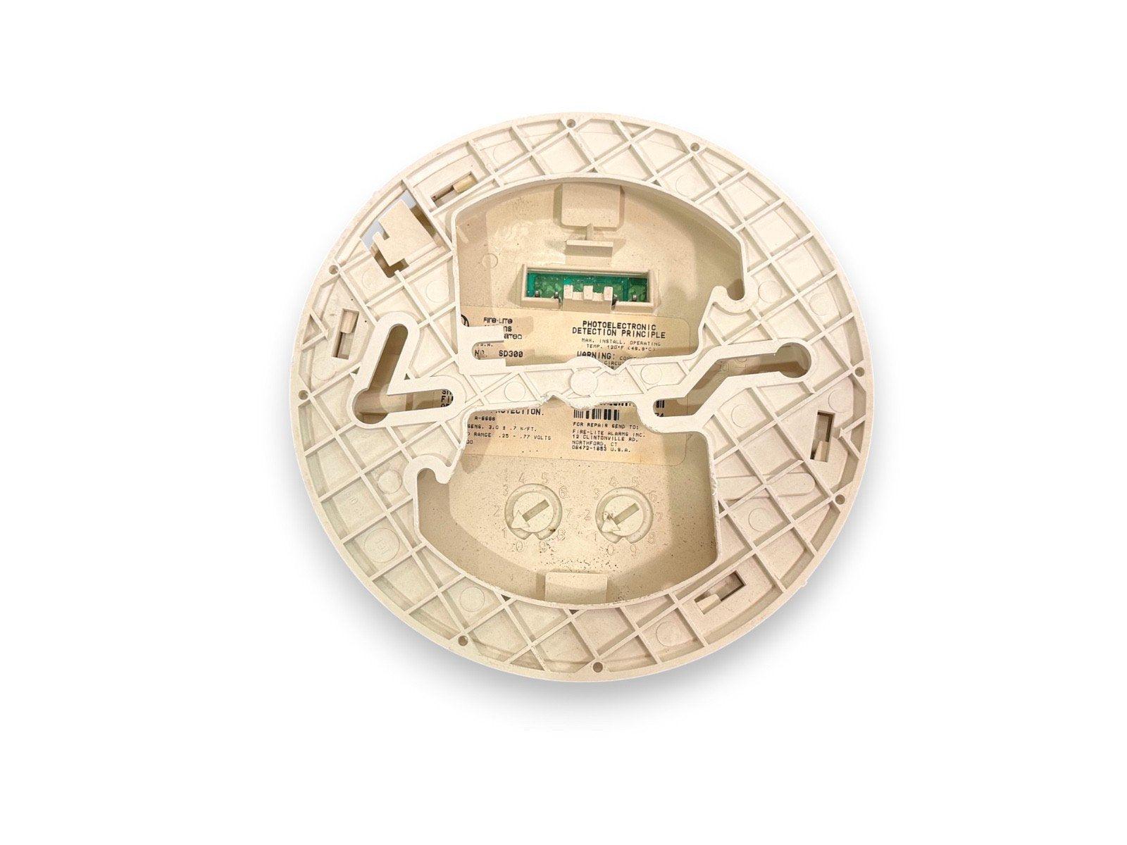 Used photoelectric smoke detector with exposed circuit board and mounting base, model SD380