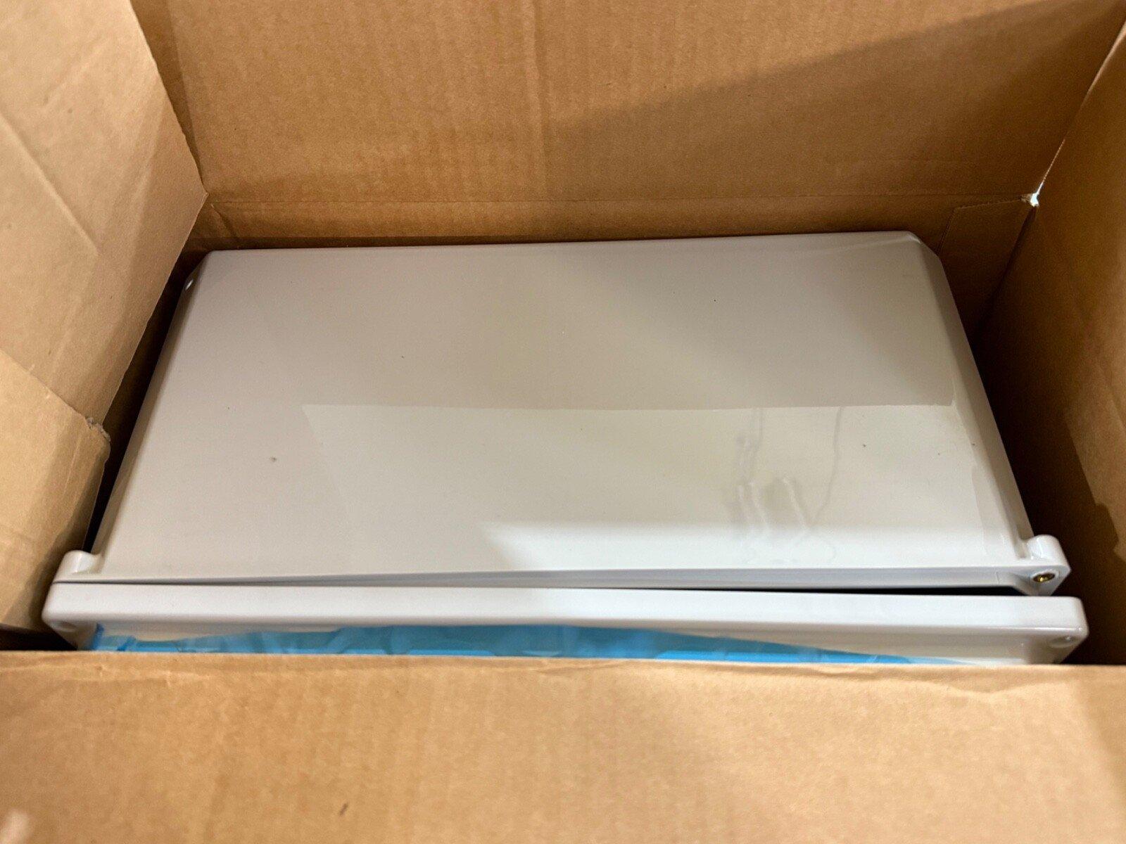 White fire alarm control panel in shipping box, new surplus equipment for safety systems