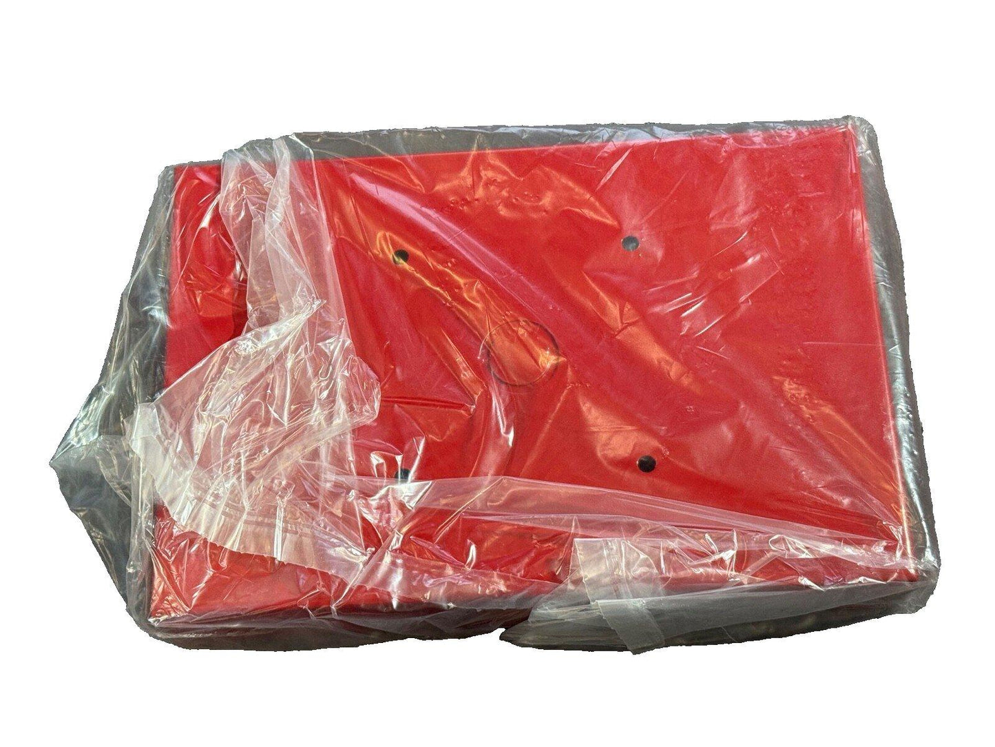 Red fire alarm control panel wrapped in plastic, ready for installation or shipping