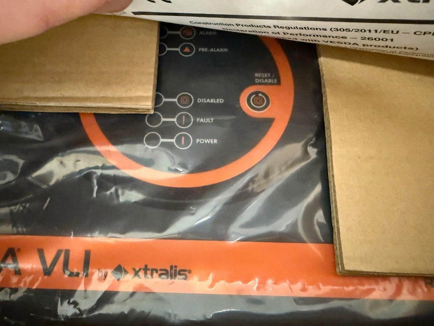 Xtralis VESDA VLI fire alarm control panel with status indicators, sealed in packaging