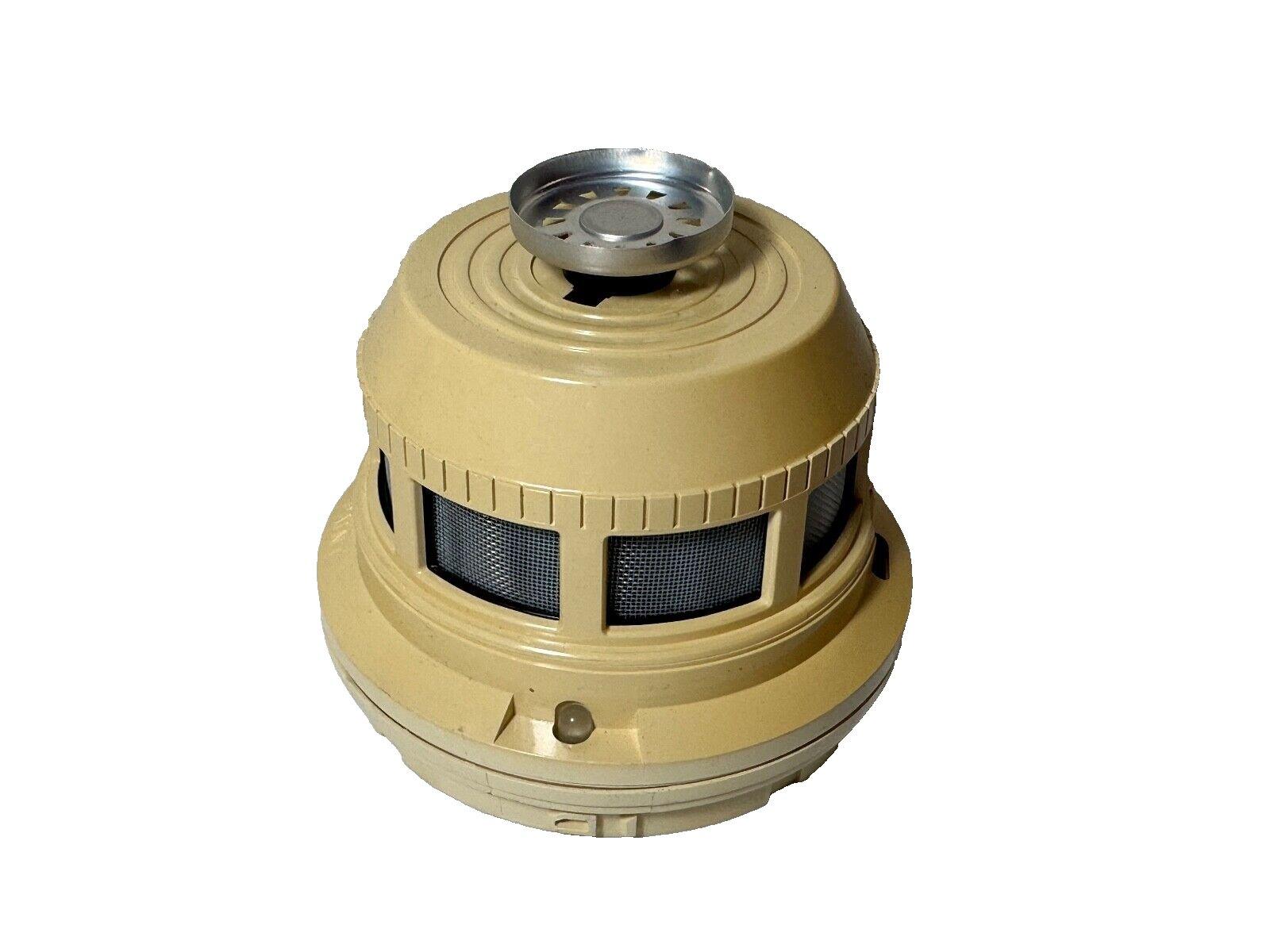 Beige fire alarm detector with mesh vents and metal top, for commercial safety systems