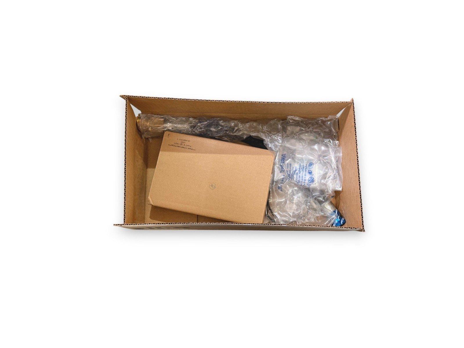 Fire alarm equipment packaged in cardboard box with bubble wrap and inner envelope for safe shipping