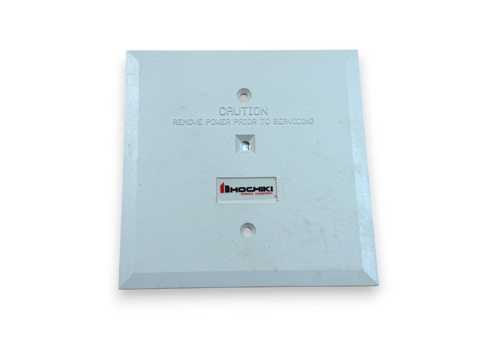 Hochiki fire alarm panel cover with caution label, used fire safety equipment