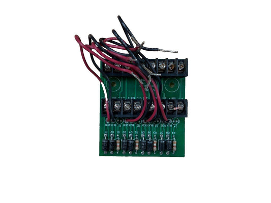 Fire alarm control module with red and black wiring, terminal blocks, and resistors on green circuit board