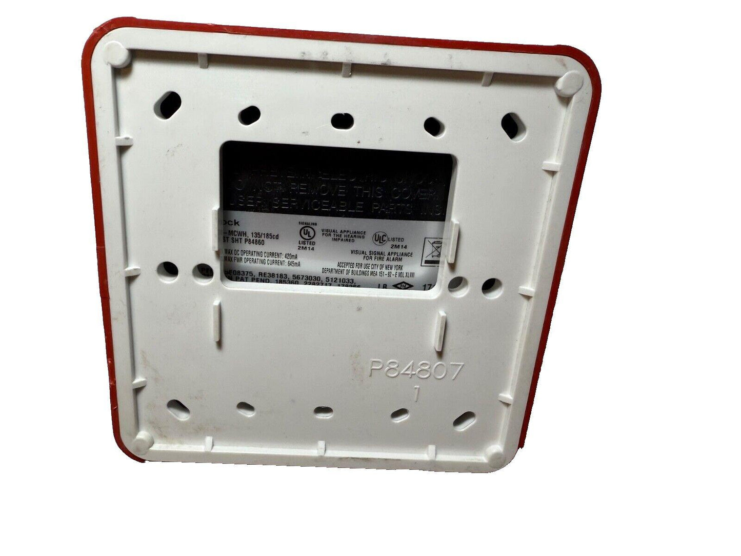 Back view of fire alarm device with UL listing and model P84807, white housing, red trim