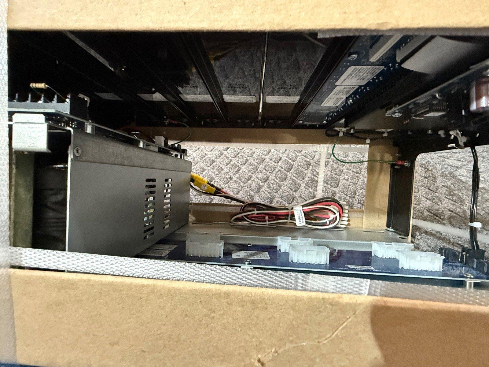 Fire alarm control panel interior with power supply, wiring, and circuit board components visible