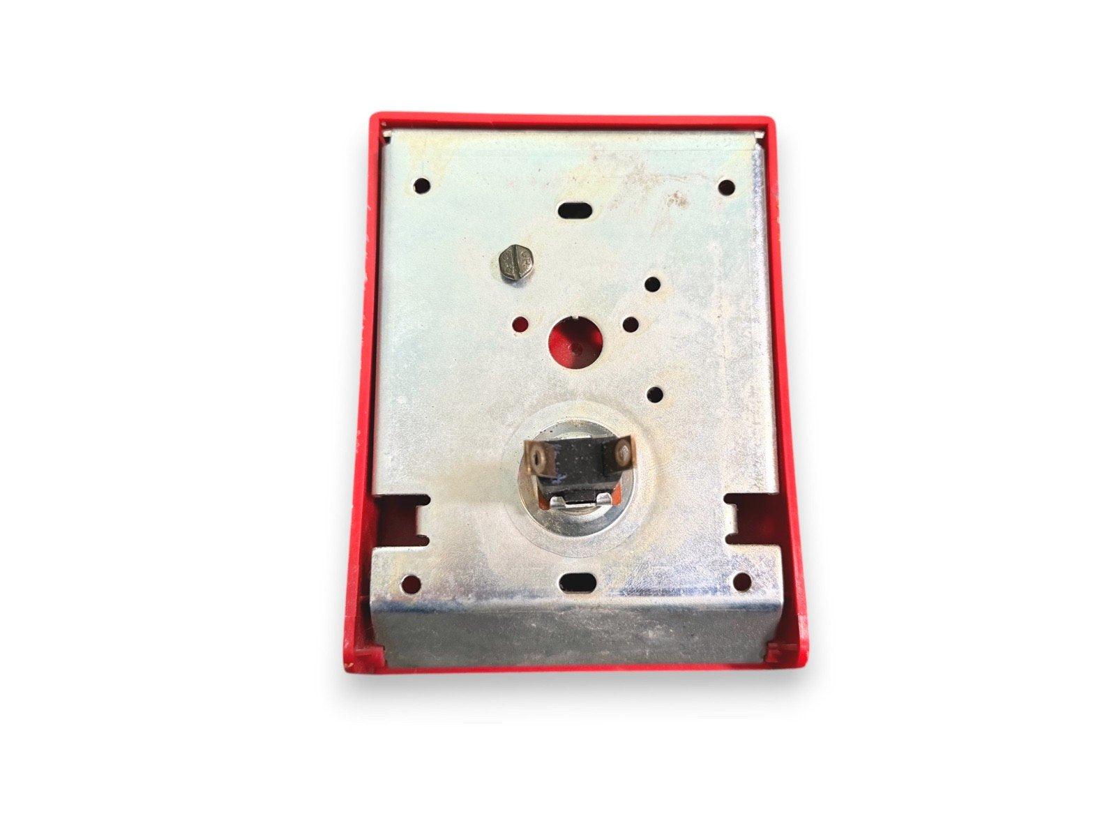 Red fire alarm pull station with metal backplate and mounting holes