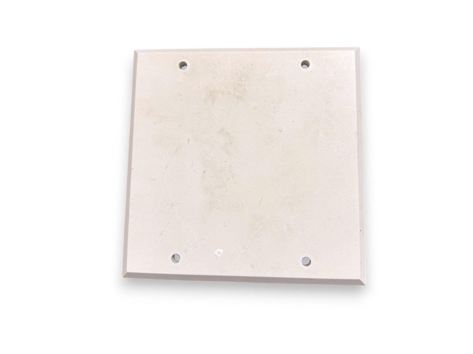 White square fire alarm mounting plate with four corner holes for secure installation