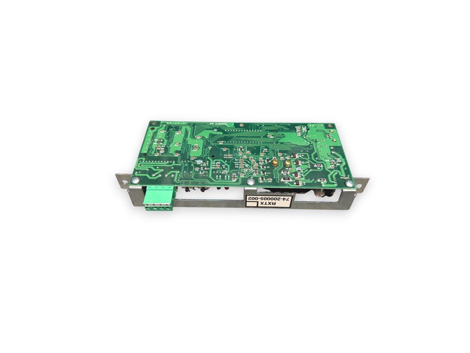 Green fire alarm control panel circuit board with RXTX label and terminal connectors