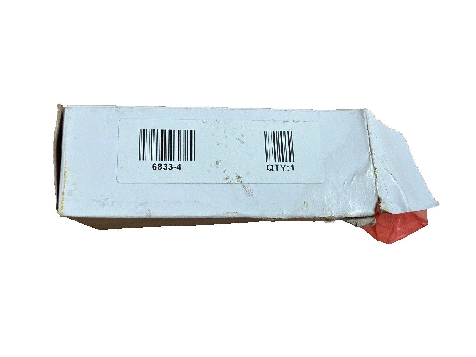 Used fire alarm equipment box with barcode 6833-4, quantity 1, showing wear and red packaging