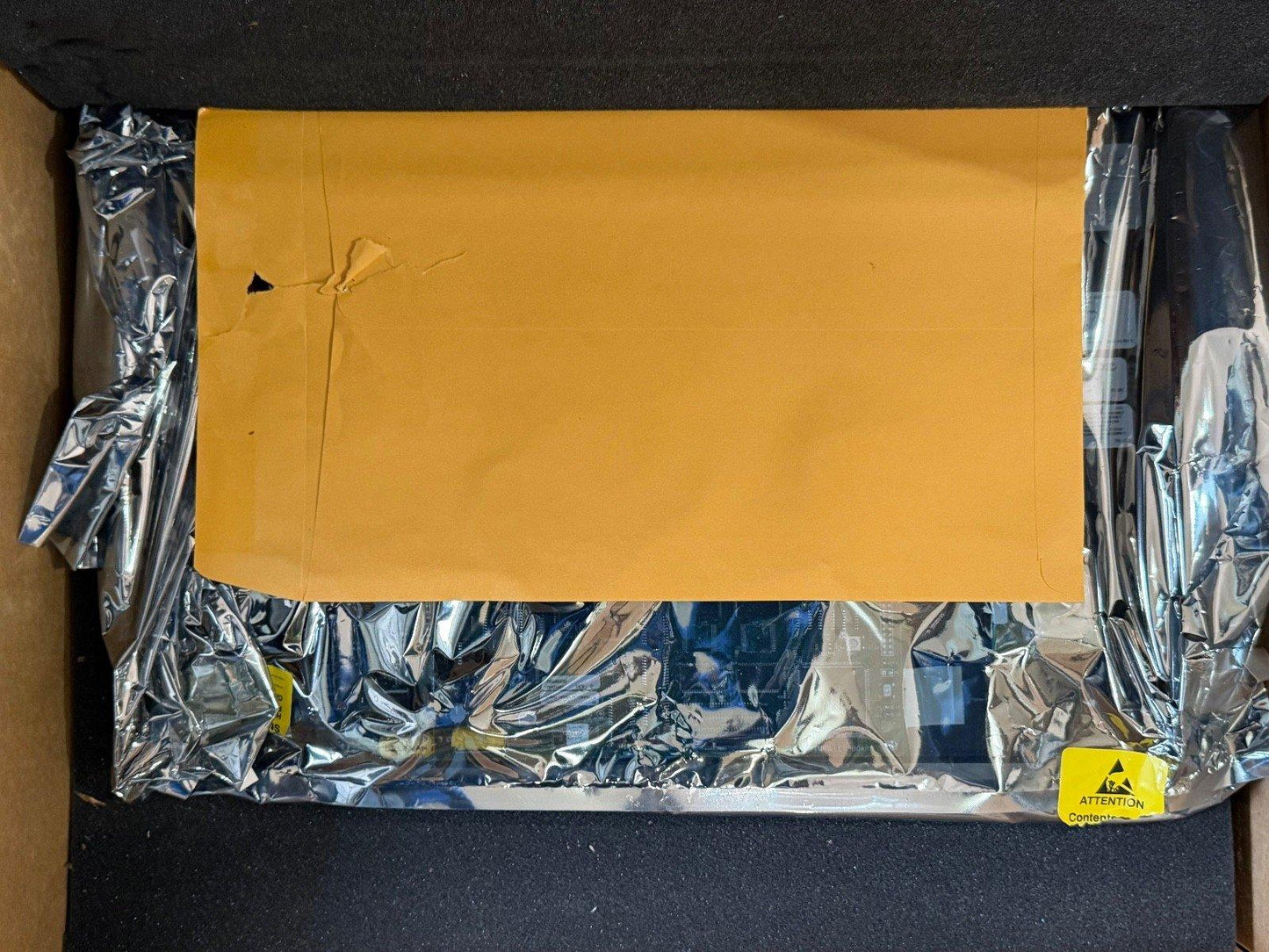 Fire alarm equipment packaged in anti-static bag with yellow envelope and warning label inside box