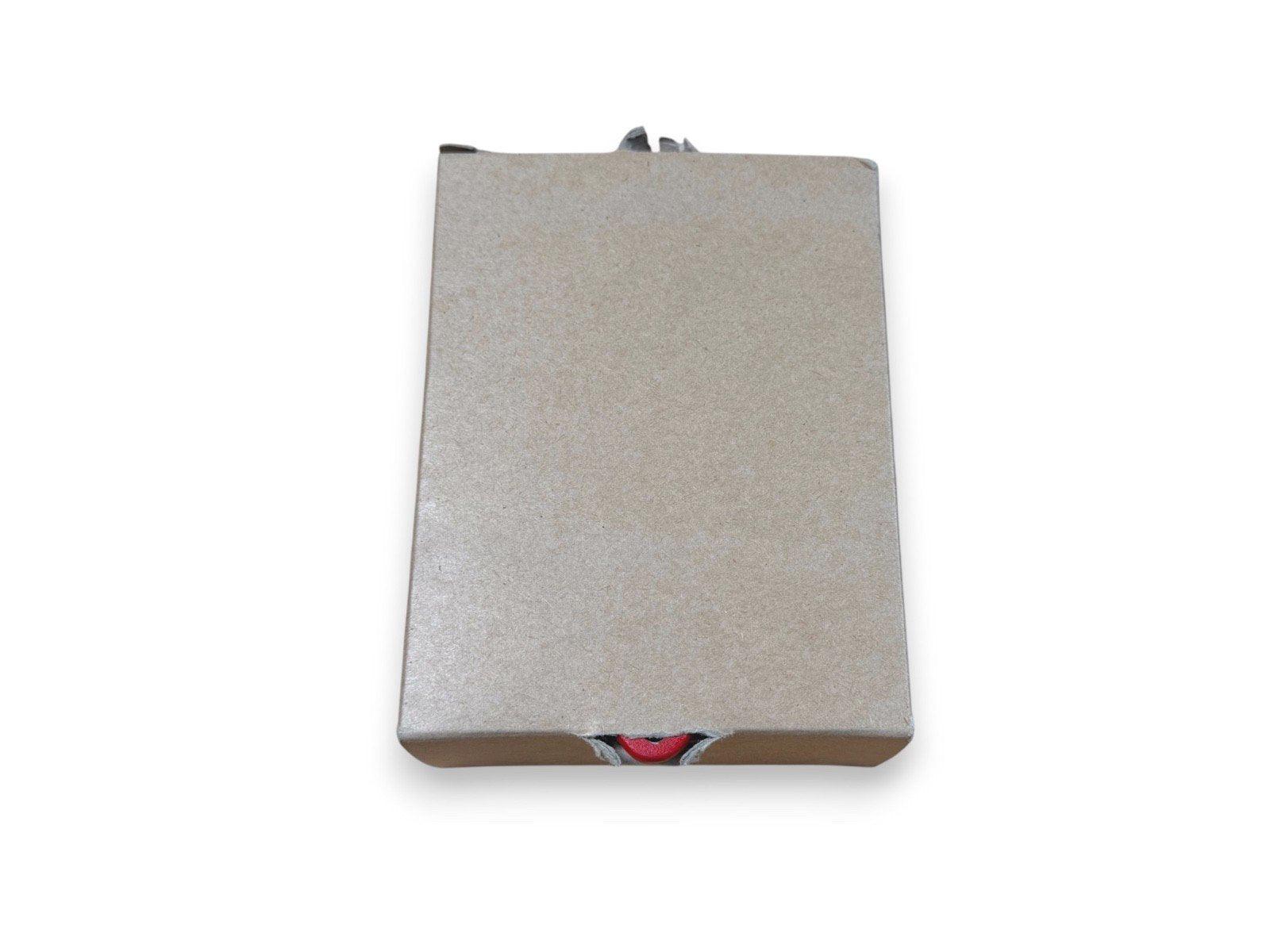 Fire alarm control panel in cardboard packaging with red indicator visible