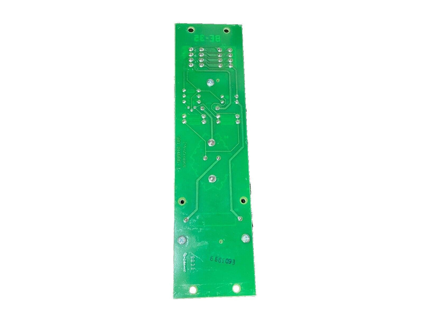 Green fire alarm control panel circuit board with solder points and mounting holes