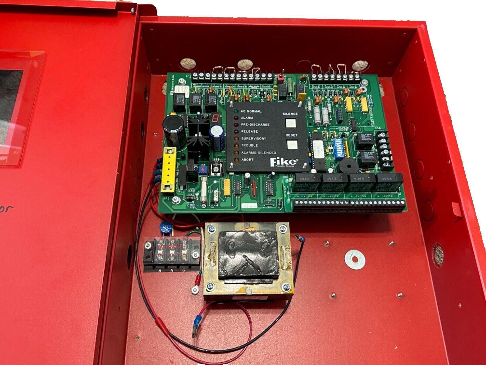 Fike fire alarm control panel with circuit board, wiring, and red enclosure for commercial fire safety systems