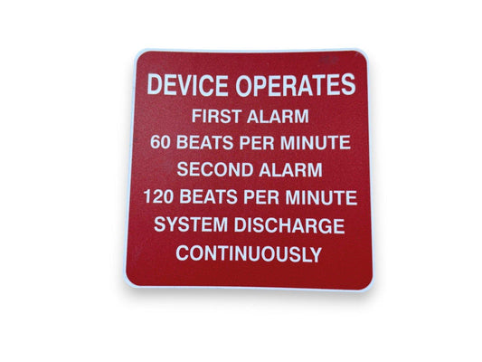 Red fire alarm system operation sign detailing first and second alarm beats per minute and continuous discharge