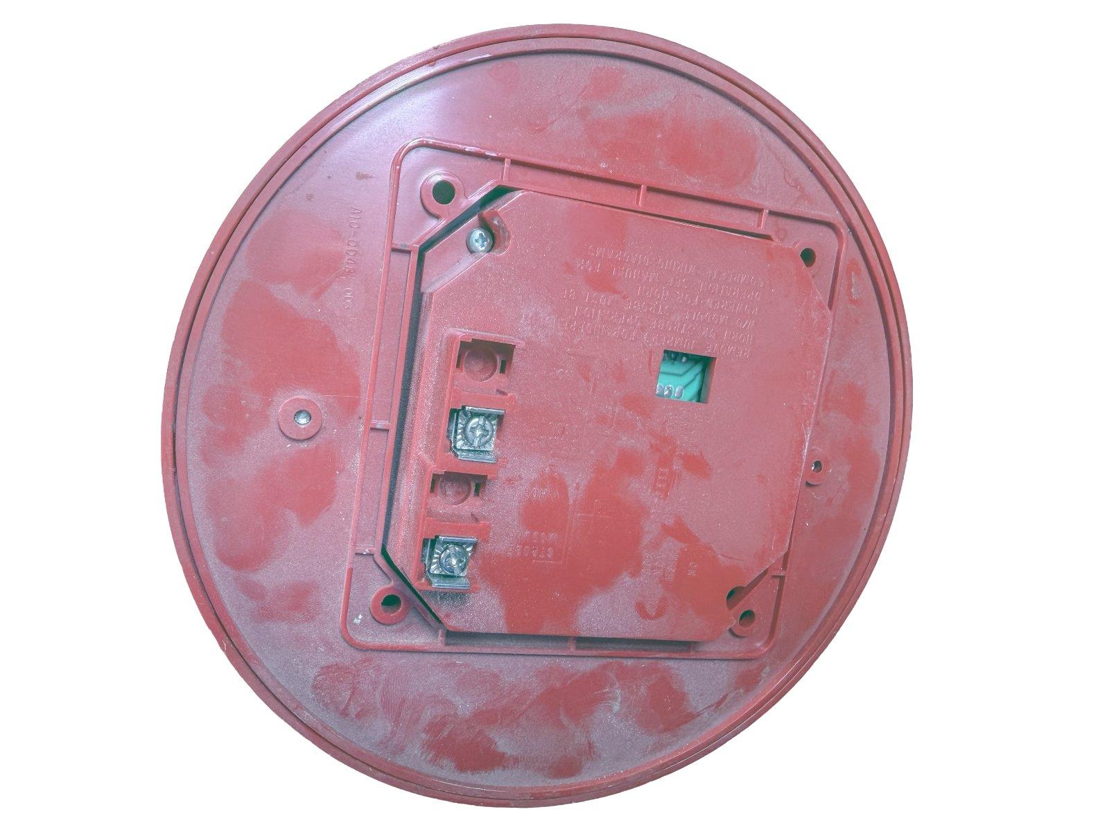 Red fire alarm detector back with wiring terminals and mounting holes