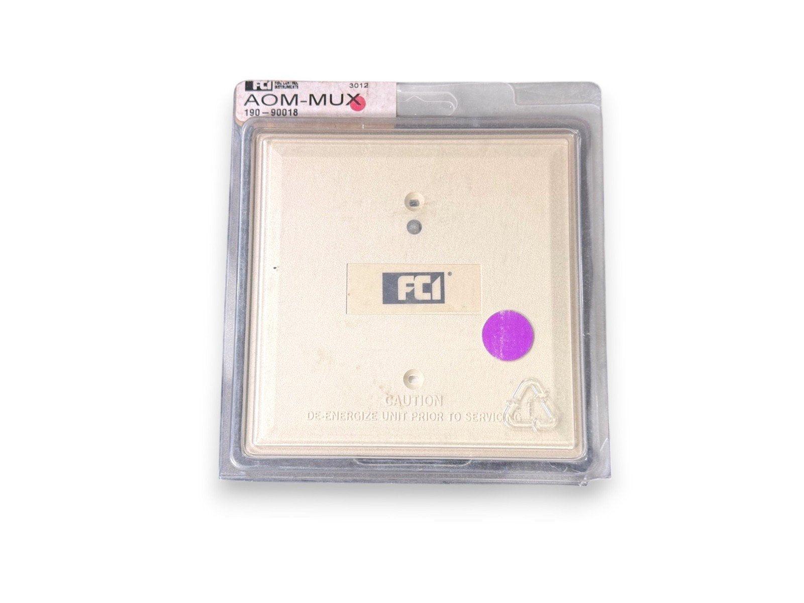 FC1 AOM-MUX fire alarm control module in sealed packaging, model 190-90018, with caution label