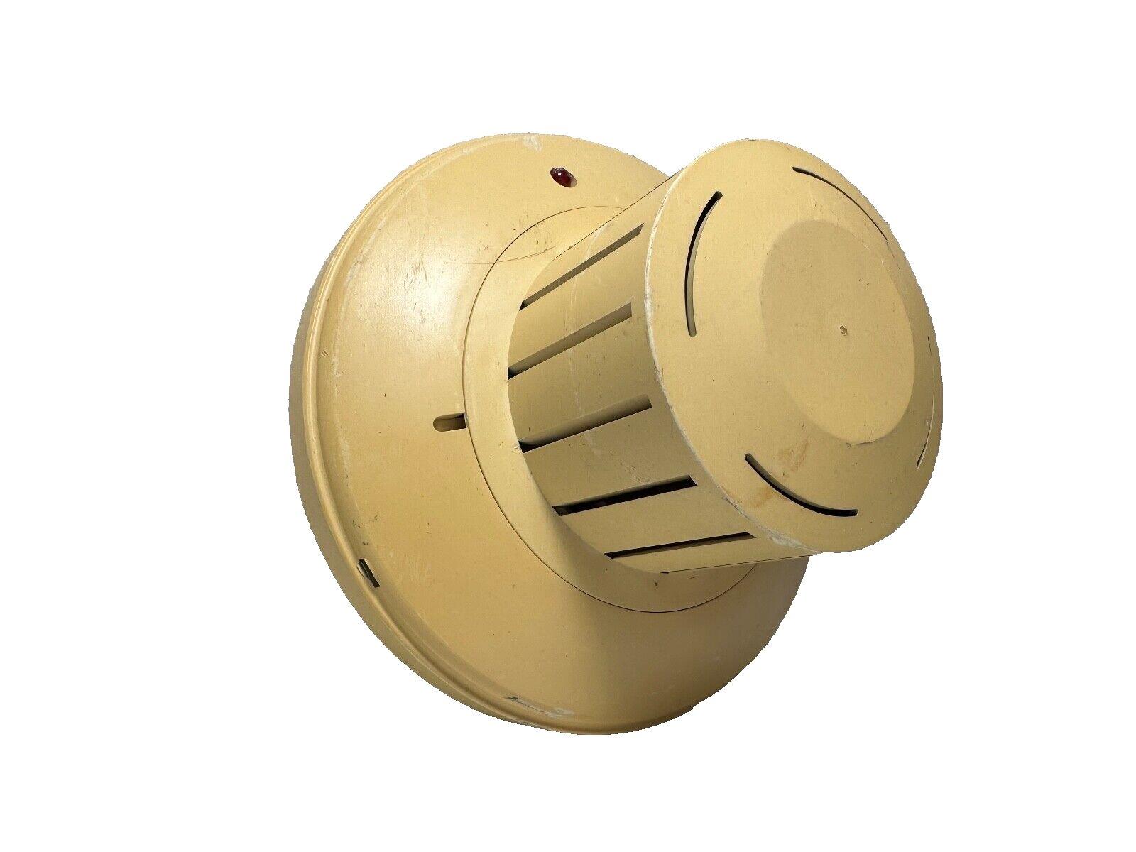 Beige fire alarm horn with red indicator light, used fire safety equipment