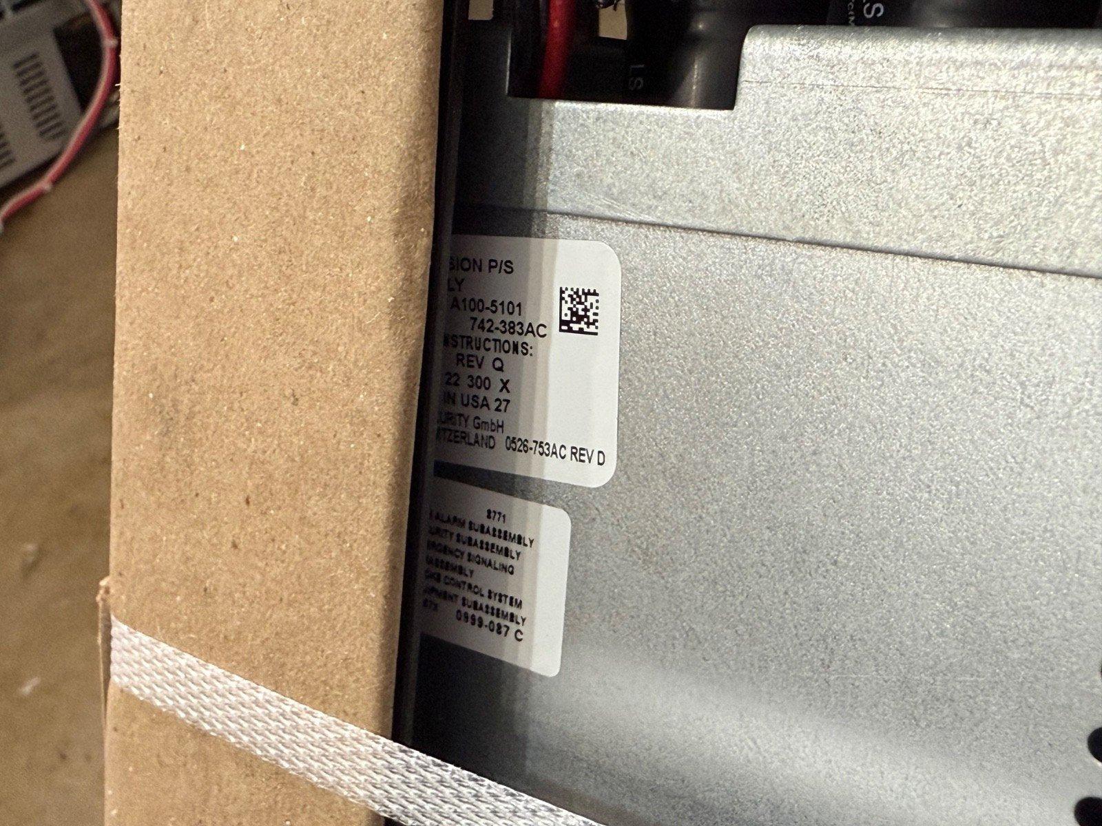 Fire alarm control panel with labels and QR code, showing model details and assembly info
